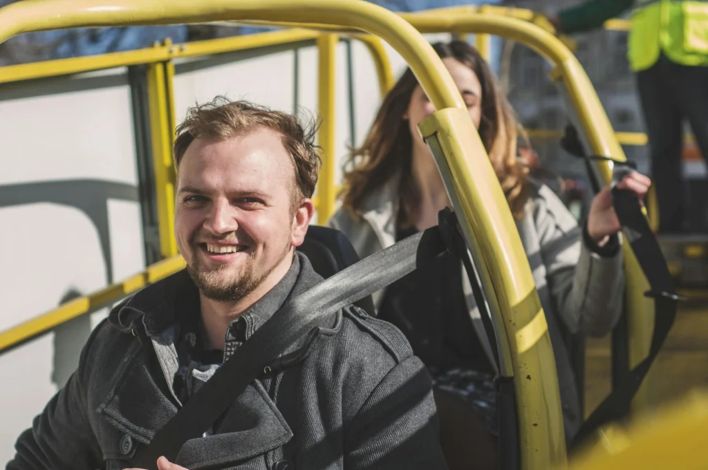 Man and Woman Riding on Yellow Framed Cart