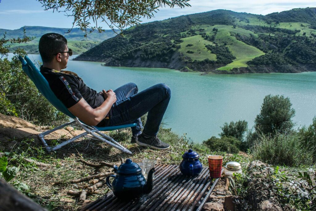 a man sitting overlooking a lake