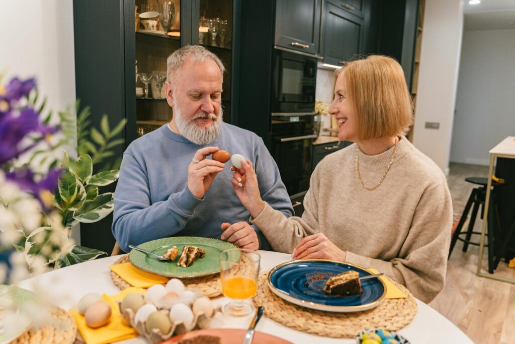 smiling elderly couple holding easter eggs