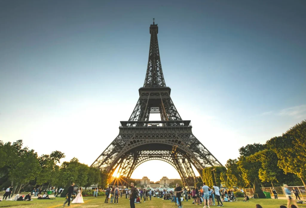 photo of people on a garden next to the Eiffel tower