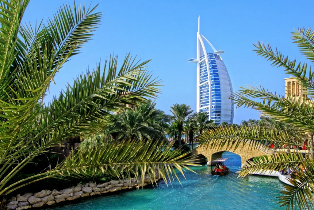 A photo of Burj Al Arab in Dubai across a canal with palm trees